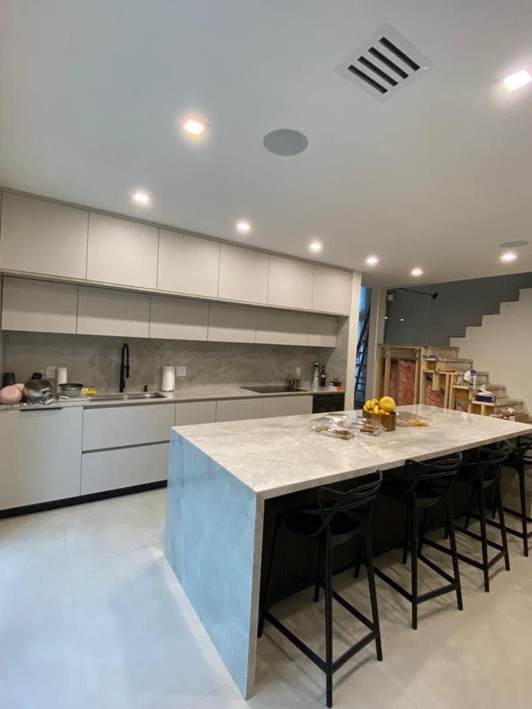Luxury kitchen island with waterfall countertop and bar seating