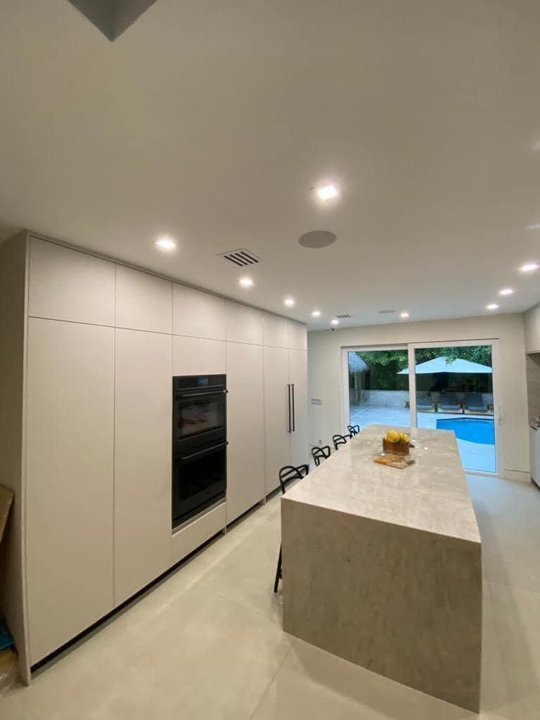 Modern kitchen with large island and pool view