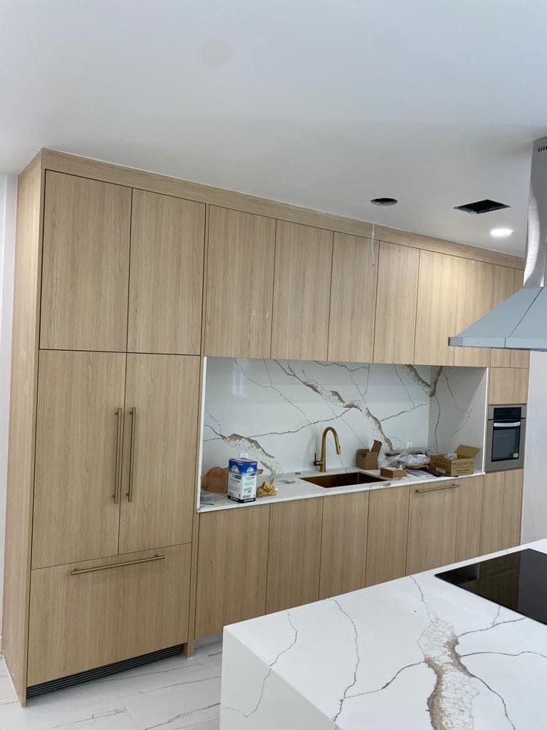 Wood-tone kitchen with open shelving and range hood