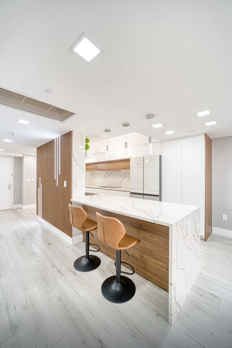 Open-concept kitchen with wood accents and bar seating