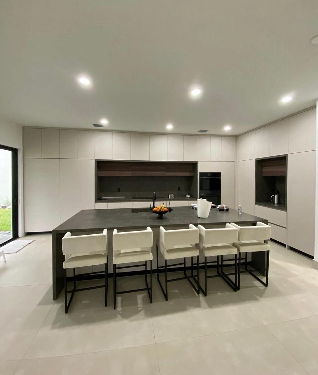 Sleek kitchen with long island and bar stools