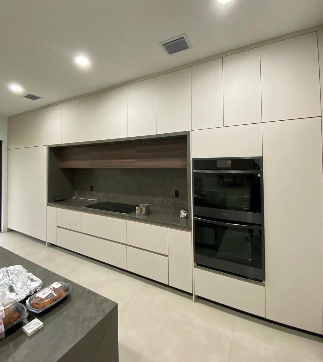 Kitchen with dark lower cabinets and long island