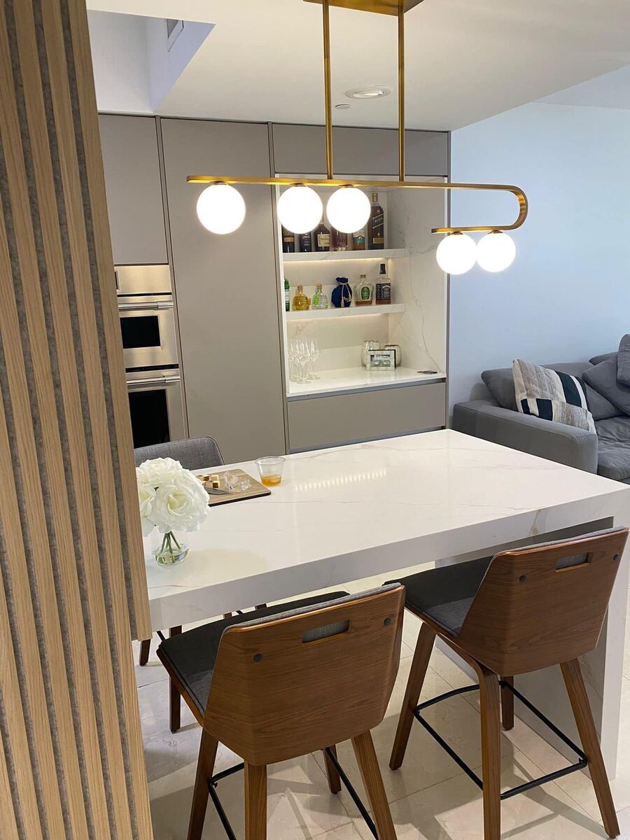 Kitchen bar area with pendant lighting and marble countertop