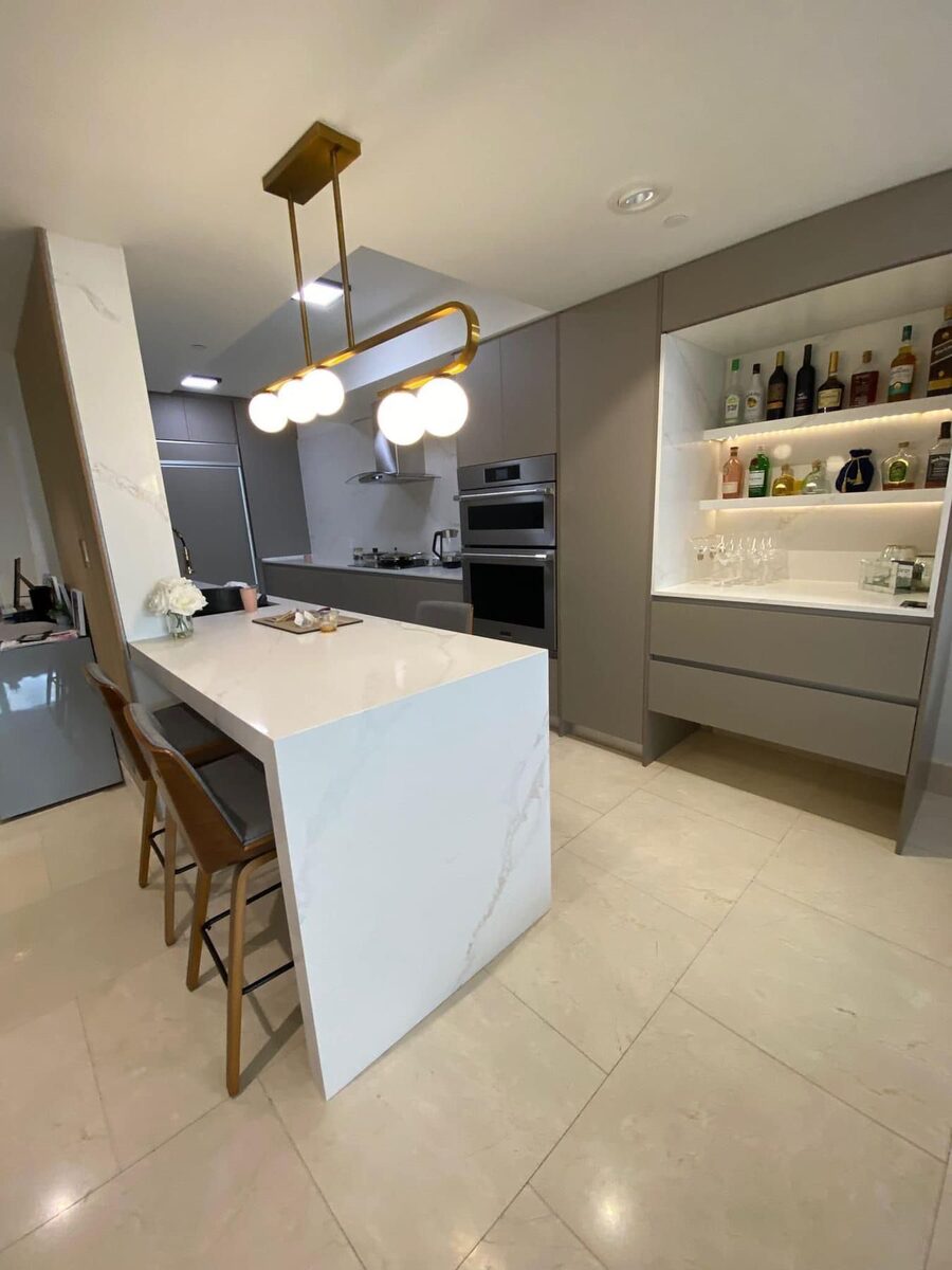 Open kitchen with white cabinetry and island seating