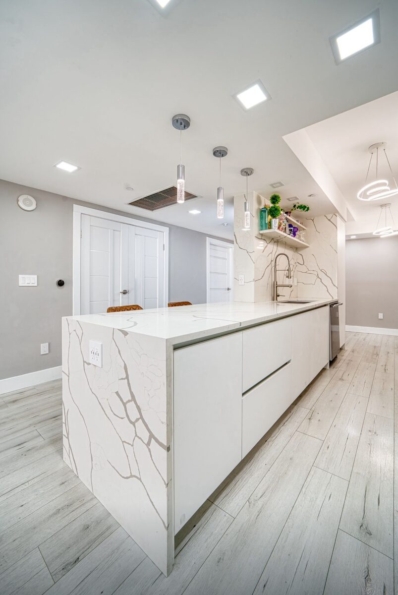 Bright white kitchen with waterfall island