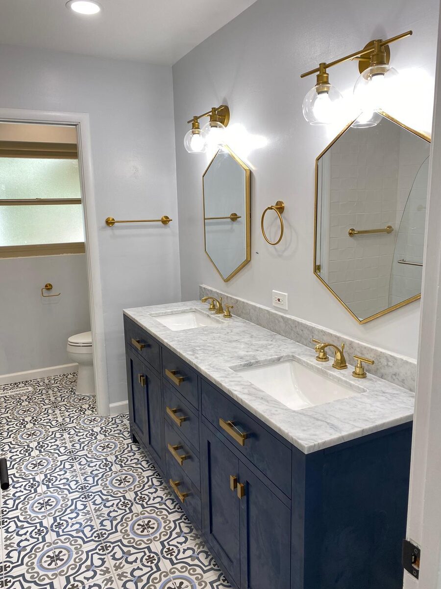 Bathroom with double vanity and gold hardware