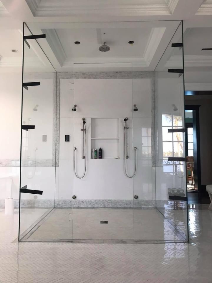 Bathroom with glass shower and marble flooring
