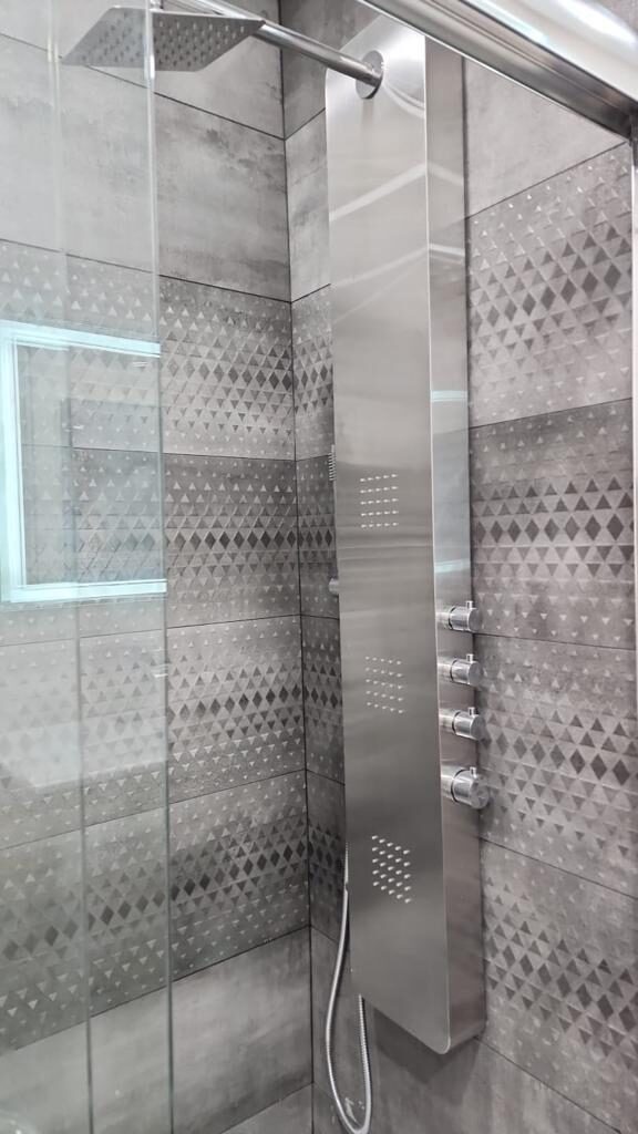 Bathroom with mosaic tile shower surround