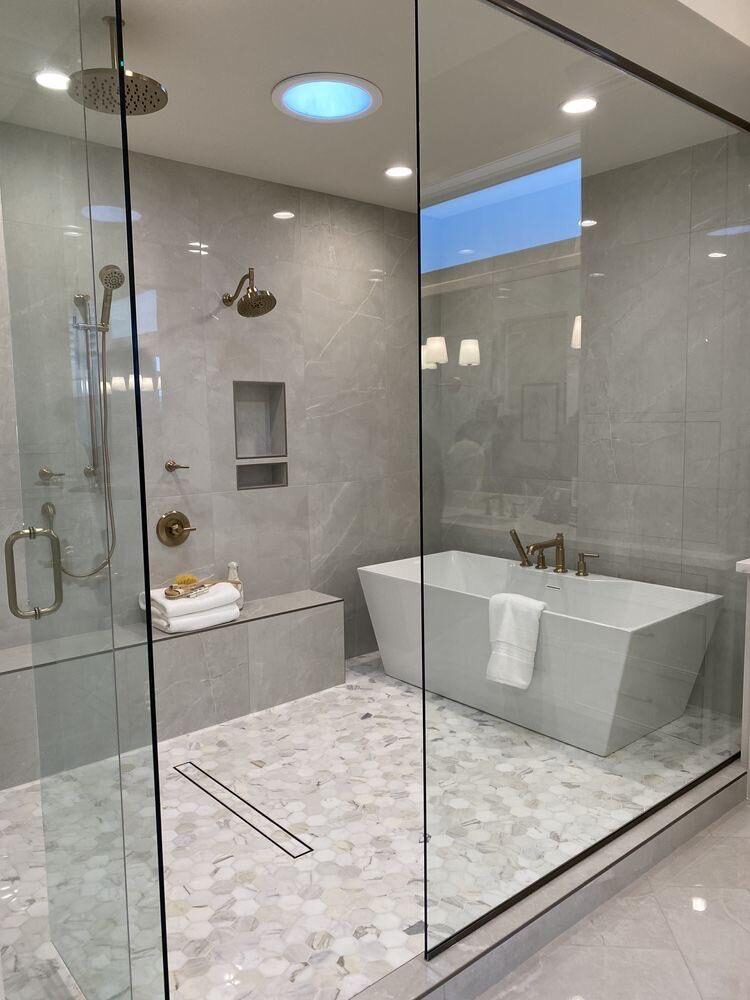 Spa-style bathroom with rainfall shower and soaking tub