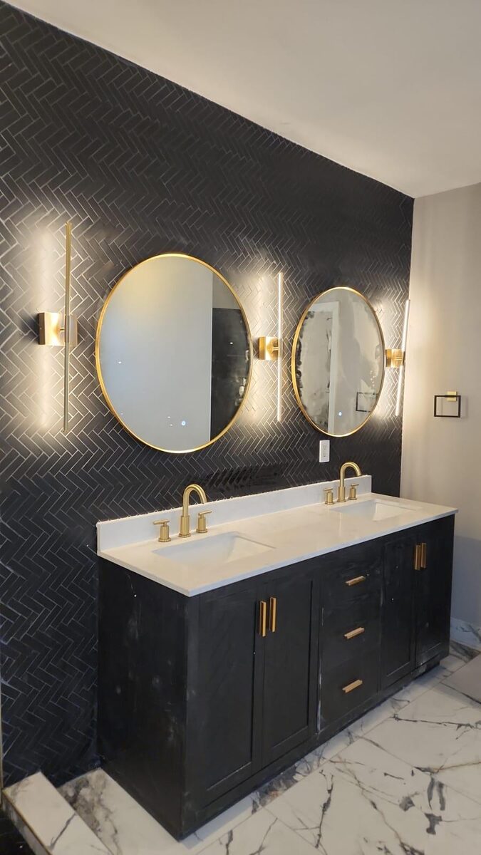 Bathroom with black vanity and round mirrors