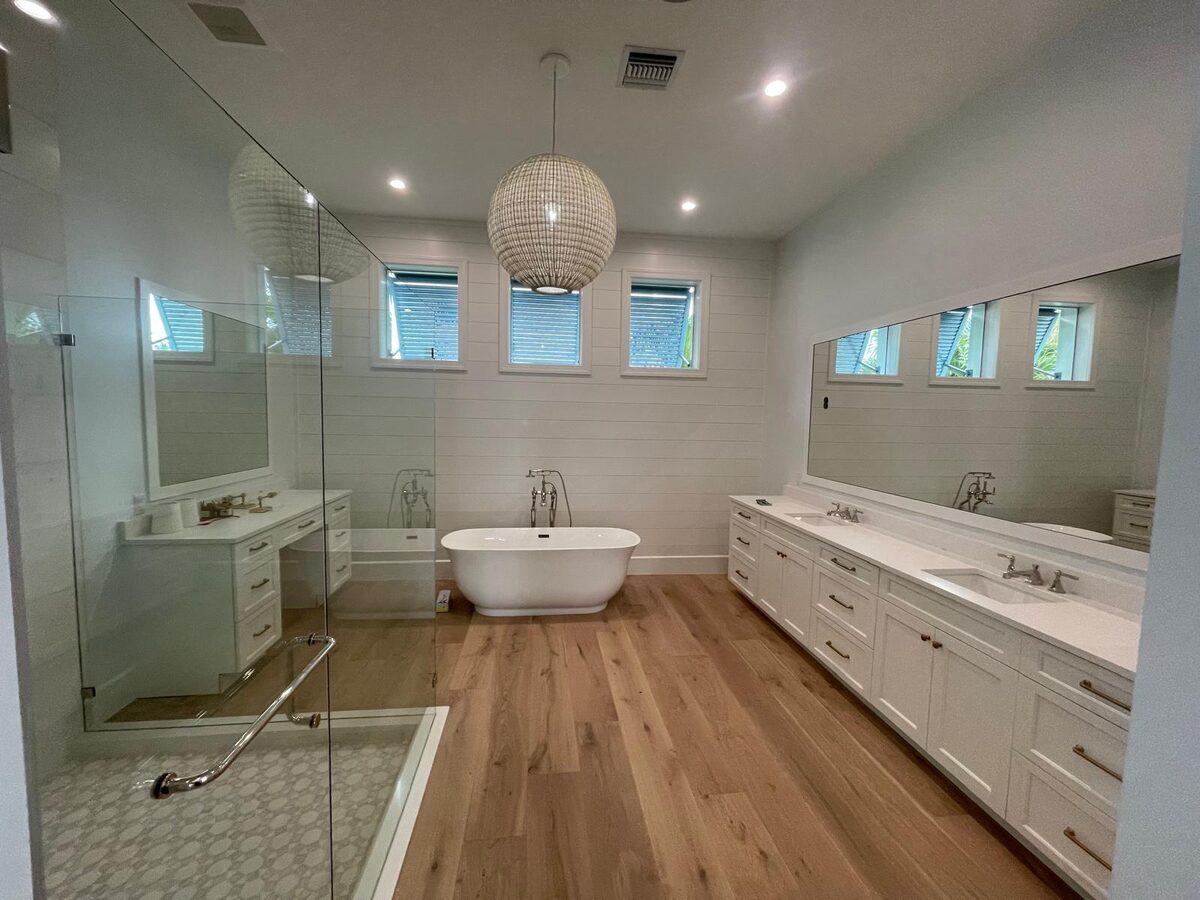 Glass-enclosed shower with tile flooring